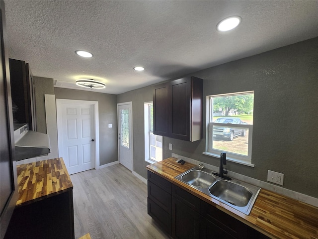 130 Jackson St N, Sulphur Springs, TX 75482 - kitchen featuring wooden counters, a textured ceiling, light wood finished floors, and recessed lighting