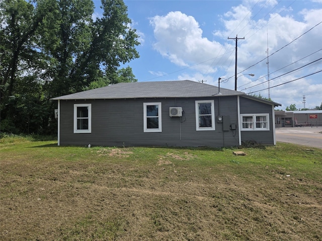 130 Jackson St N, Sulphur Springs, TX 75482 - view of side of property with a wall mounted air conditioner and a yard