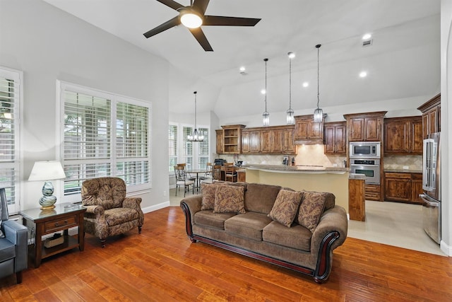 2428 Lilyfield Dr, Trophy Club, TX 76262 - living area with ceiling fan, lofted ceiling, light wood-style floors, and a chandelier