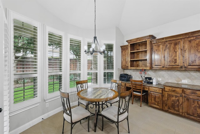 2428 Lilyfield Dr, Trophy Club, TX 76262 - dining room with plenty of natural light, a chandelier, built in desk, and vaulted ceiling