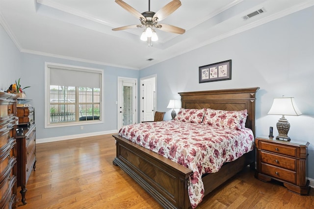 2428 Lilyfield Dr, Trophy Club, TX 76262 - bedroom featuring a tray ceiling, light wood finished floors, crown molding, and a ceiling fan