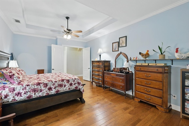 2428 Lilyfield Dr, Trophy Club, TX 76262 - bedroom featuring a tray ceiling, wood-type flooring, ornamental molding, and a ceiling fan