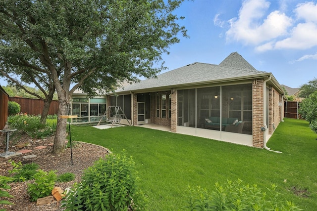 2428 Lilyfield Dr, Trophy Club, TX 76262 - back of house with a sunroom, a fenced backyard, brick siding, and roof with shingles