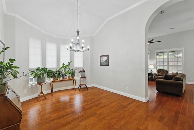 2428 Lilyfield Dr, Trophy Club, TX 76262 - dining space featuring arched walkways, a chandelier, wood finished floors, ceiling fan, and vaulted ceiling