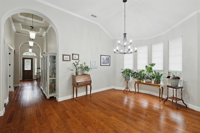 2428 Lilyfield Dr, Trophy Club, TX 76262 - entryway featuring a towering ceiling, wood-type flooring, arched walkways, crown molding, and a chandelier
