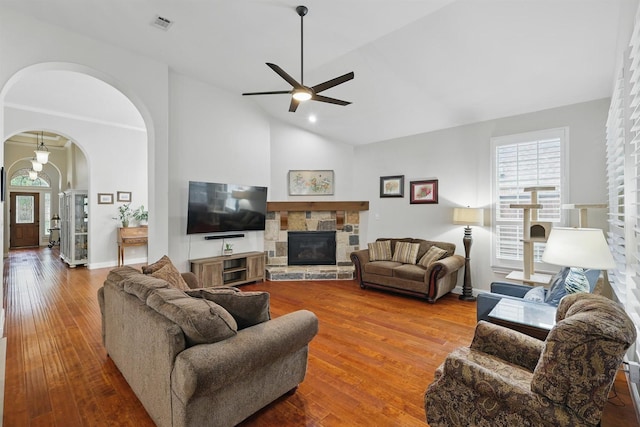 2428 Lilyfield Dr, Trophy Club, TX 76262 - living area featuring a ceiling fan, arched walkways, hardwood / wood-style flooring, a fireplace, and high vaulted ceiling