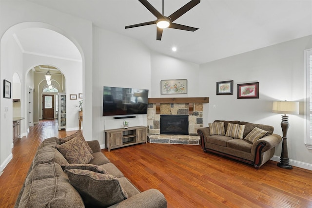 2428 Lilyfield Dr, Trophy Club, TX 76262 - living room featuring arched walkways, hardwood / wood-style flooring, ceiling fan, vaulted ceiling, and a stone fireplace