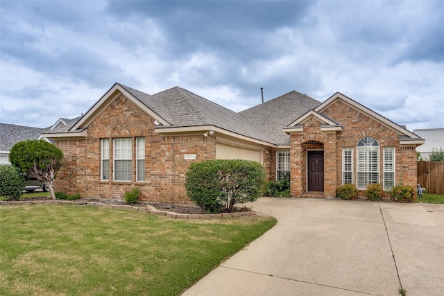 10715 Robincreek Ln, Frisco, TX 75035 - traditional home with brick siding, driveway, a garage, and a shingled roof
