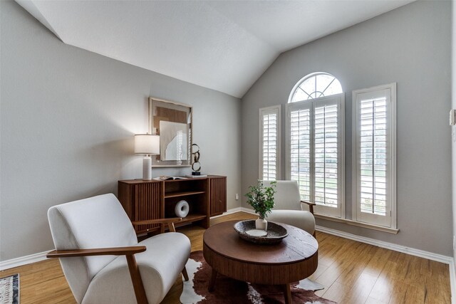 10715 Robincreek Ln, Frisco, TX 75035 - sitting room with vaulted ceiling and wood finished floors