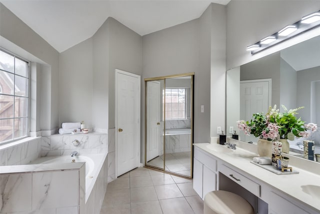 10715 Robincreek Ln, Frisco, TX 75035 - bathroom with double vanity, a bath, vaulted ceiling, and tile patterned flooring