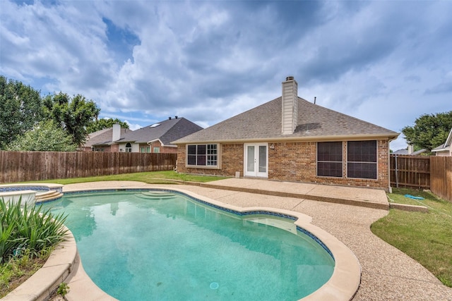 10715 Robincreek Ln, Frisco, TX 75035 - view of swimming pool with a fenced backyard, a patio area, french doors, and a pool with connected hot tub