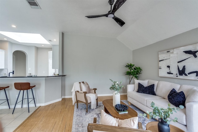 10715 Robincreek Ln, Frisco, TX 75035 - living area featuring ceiling fan, light wood-style flooring, recessed lighting, a skylight, and arched walkways