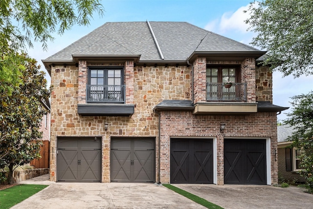 5513 Martel Ave, Dallas, TX 75206 - french provincial home with a balcony, an attached garage, concrete driveway, and a shingled roof