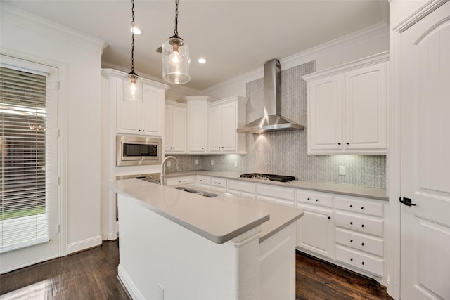5513 Martel Ave, Dallas, TX 75206 - kitchen with wall chimney range hood, stainless steel microwave, gas stovetop, tasteful backsplash, and ornamental molding