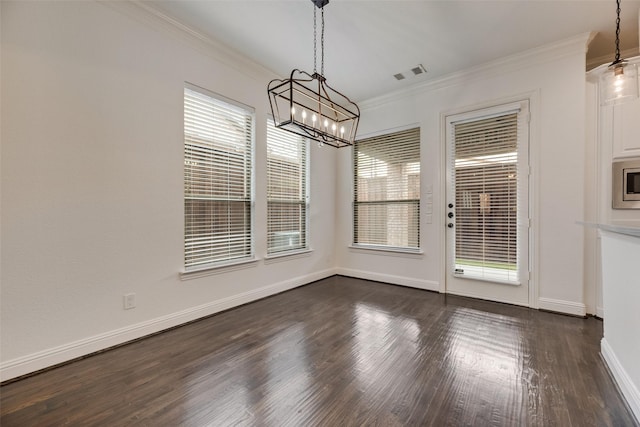 5513 Martel Ave, Dallas, TX 75206 - unfurnished dining area with a chandelier, crown molding, and dark wood-style floors