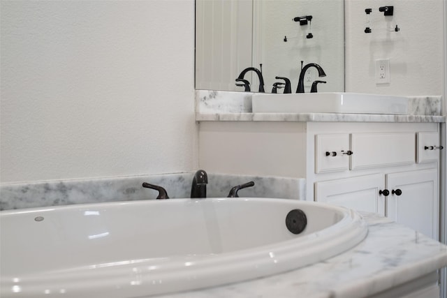 5513 Martel Ave, Dallas, TX 75206 - bathroom featuring vanity, a soaking tub, and a textured wall