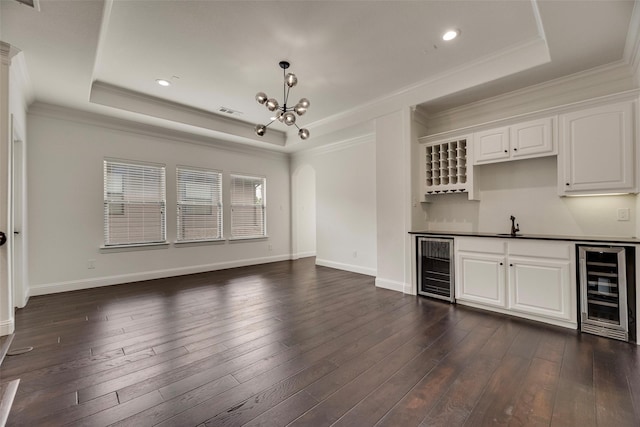5513 Martel Ave, Dallas, TX 75206 - indoor wet bar featuring beverage cooler, a tray ceiling, ornamental molding, a chandelier, and pendant lighting