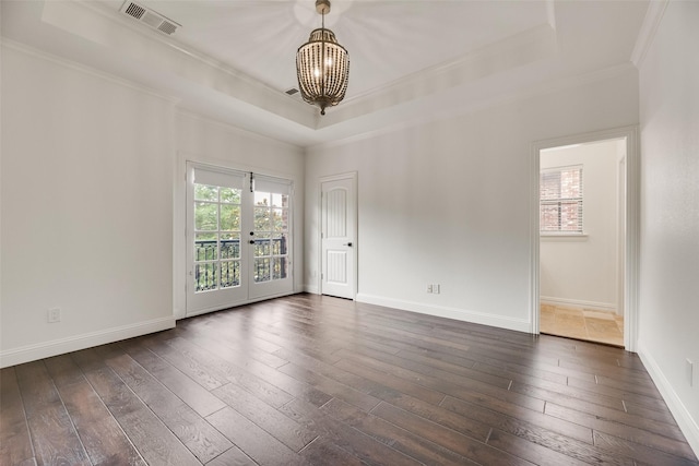 5513 Martel Ave, Dallas, TX 75206 - unfurnished room featuring a chandelier, crown molding, a tray ceiling, and dark wood-type flooring