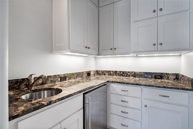 3619 Harvard Ave, Highland Park, TX 75205 - kitchen with fridge, white cabinetry, and dark stone countertops