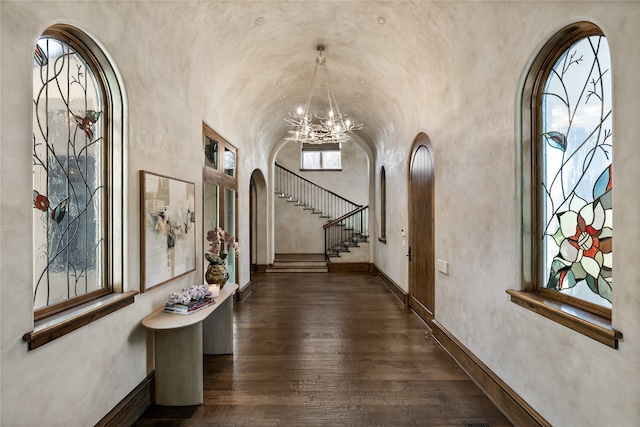 3619 Harvard Ave, Highland Park, TX 75205 - foyer entrance featuring arched walkways, a chandelier, dark wood-style floors, and stairs