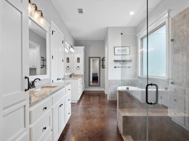 3628 S Fm 1655, Chico, TX 76431 - bathroom with two vanities, a bath, a stall shower, and concrete floors