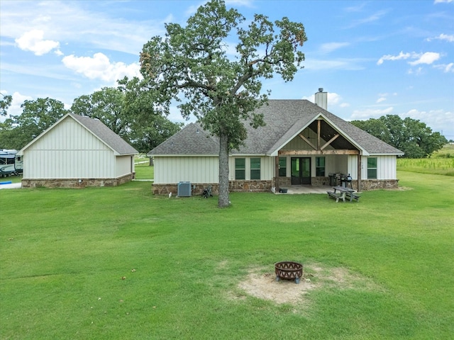 3628 S Fm 1655, Chico, TX 76431 - back of house with a fire pit, roof with shingles, a lawn, and a chimney