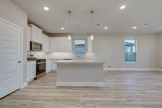 3104 Dixondale Dr, Fort Worth, TX 76108 - kitchen featuring stainless steel appliances, plenty of natural light, backsplash, a center island, and recessed lighting