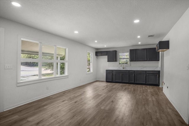 8208 Kender Ln, White Settlement, TX 76108 - unfurnished living room featuring wood finished floors, a textured ceiling, and recessed lighting