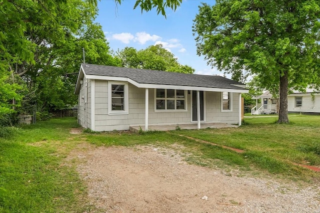 8208 Kender Ln, White Settlement, TX 76108 - view of front of house with a front yard, a porch, and roof with shingles