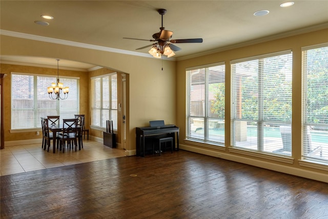 11819 Coronado Trl, Frisco, TX 75033 - living area featuring healthy amount of natural light, a chandelier, a ceiling fan, wood finished floors, and ornamental molding