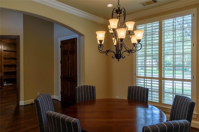 11819 Coronado Trl, Frisco, TX 75033 - dining space with arched walkways, a chandelier, dark wood finished floors, ornamental molding, and recessed lighting