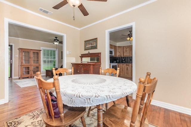 1401 W Shepherd St, Denison, TX 75020 - dining space featuring ceiling fan, light wood-style floors, and ornamental molding