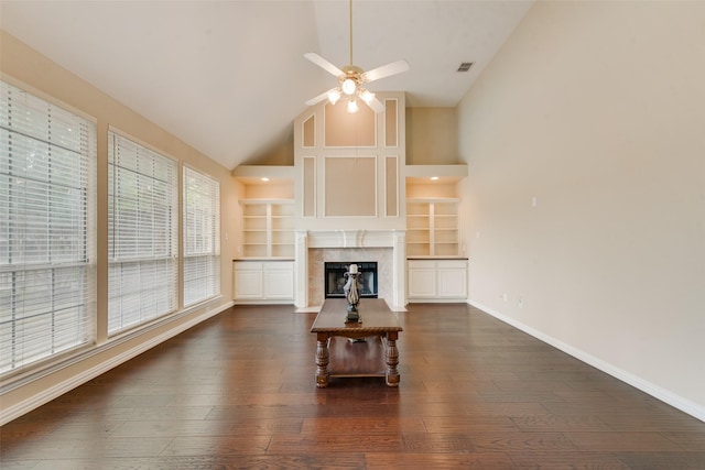 1907 New Haven Rd, Grapevine, TX 76051 - unfurnished living room featuring a ceiling fan, high vaulted ceiling, dark wood finished floors, a tile fireplace, and built in features