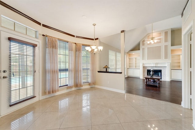 1907 New Haven Rd, Grapevine, TX 76051 - unfurnished dining area featuring light tile patterned flooring, a chandelier, built in shelves, a premium fireplace, and a ceiling fan