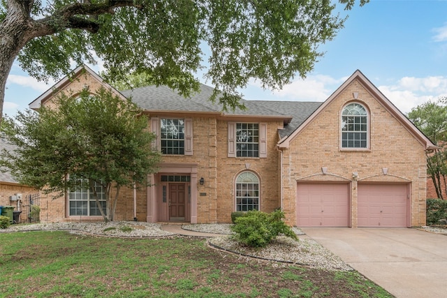 1907 New Haven Rd, Grapevine, TX 76051 - view of front of property with concrete driveway, an attached garage, brick siding, a shingled roof, and a front lawn