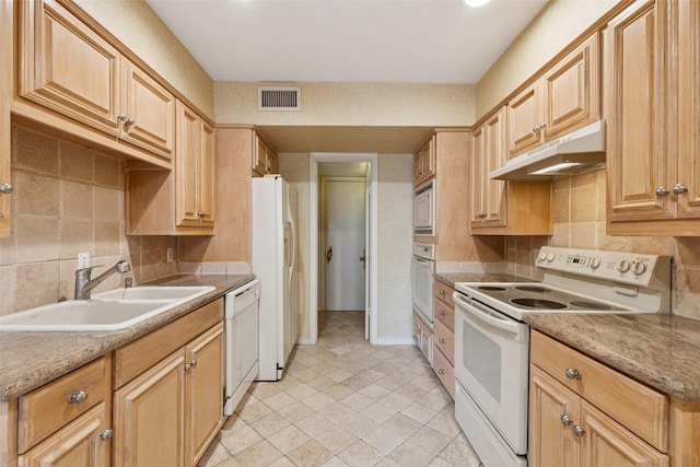 6325 Bandera Ave Unit C, Dallas, TX 75225 - kitchen featuring white appliances, under cabinet range hood, backsplash, and light tile patterned floors