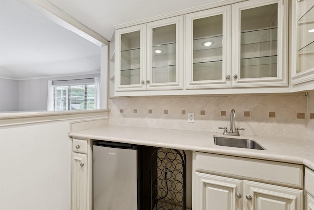 6325 Bandera Ave Unit C, Dallas, TX 75225 - kitchen with stainless steel refrigerator, light countertops, tasteful backsplash, and glass insert cabinets