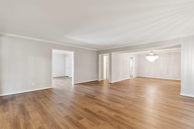 6325 Bandera Ave Unit C, Dallas, TX 75225 - unfurnished living room with light wood finished floors, crown molding, and a chandelier