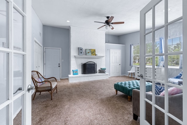 2318 Holsum Cir, Greenville, TX 75401 - carpeted living area featuring a ceiling fan and a fireplace