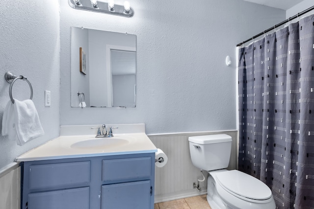 2318 Holsum Cir, Greenville, TX 75401 - bathroom with vanity, wainscoting, tile patterned floors, a shower with shower curtain, and wood walls