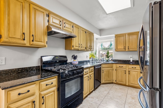 1638 Glencairn Ln, Lewisville, TX 75067 - kitchen with black appliances, under cabinet range hood, dark stone counters, and light tile patterned flooring
