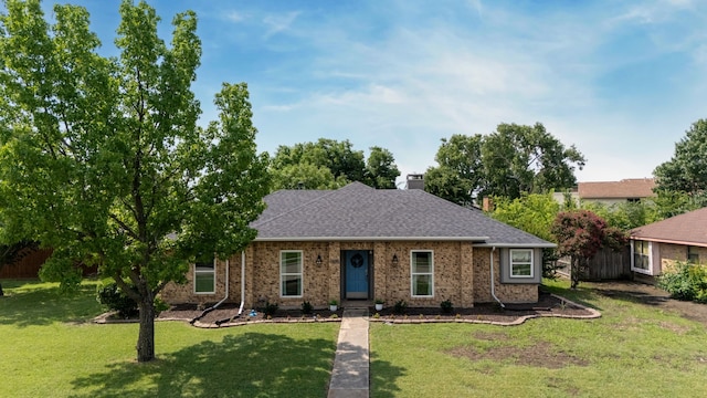 1638 Glencairn Ln, Lewisville, TX 75067 - view of front of house with a front yard, a chimney, brick siding, and a shingled roof