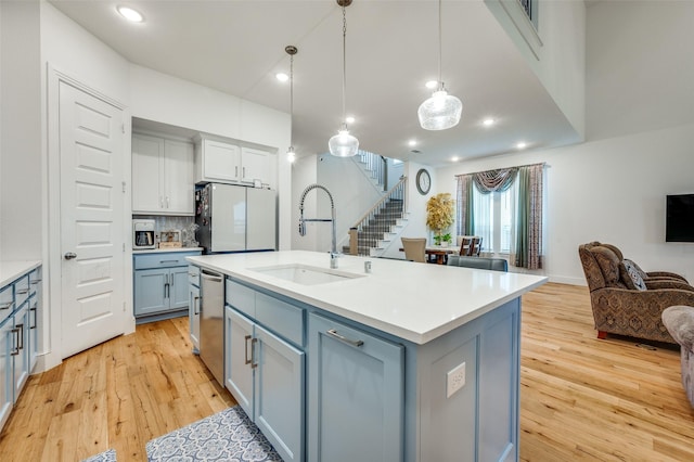 4017 Prickly Pear Ave, Aubrey, TX 76227 - kitchen featuring freestanding refrigerator, open floor plan, light wood finished floors, backsplash, and recessed lighting