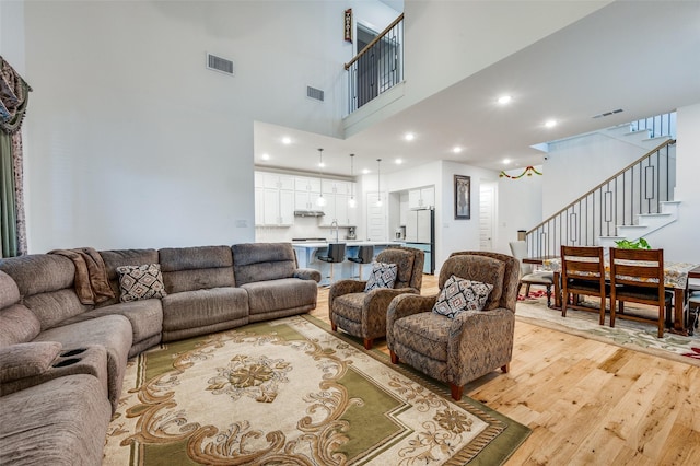 4017 Prickly Pear Ave, Aubrey, TX 76227 - living area featuring light wood-style flooring, stairs, a high ceiling, and recessed lighting