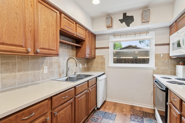 2318 Valleywood Dr, Carrollton, TX 75006 - kitchen featuring white appliances, light countertops, light wood-style flooring, and brown cabinetry