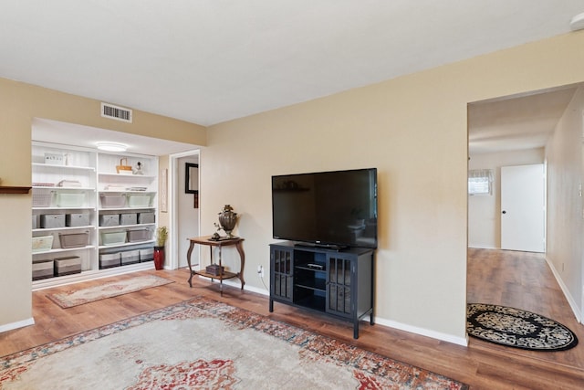 2318 Valleywood Dr, Carrollton, TX 75006 - living area featuring wood finished floors and baseboards