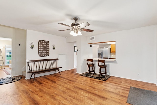 2318 Valleywood Dr, Carrollton, TX 75006 - living area with a ceiling fan and light wood-style floors