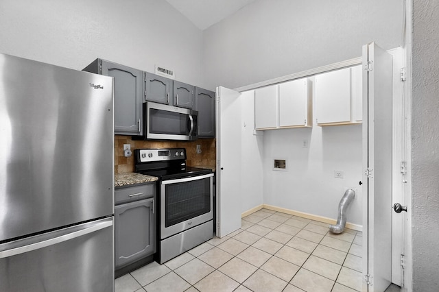5644 Powers St, The Colony, TX 75056 - kitchen with stainless steel appliances, gray cabinetry, and light tile patterned floors