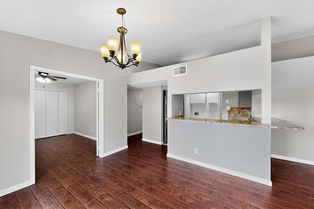 5644 Powers St, The Colony, TX 75056 - unfurnished living room featuring dark wood-style flooring, a chandelier, and a ceiling fan