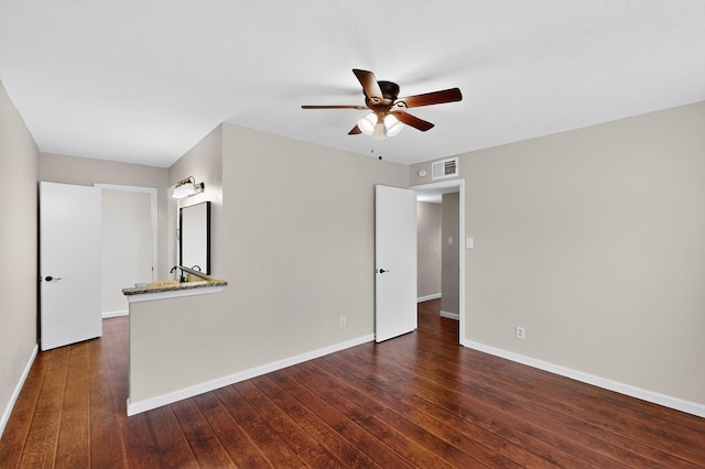 5644 Powers St, The Colony, TX 75056 - empty room with a ceiling fan and dark wood-type flooring